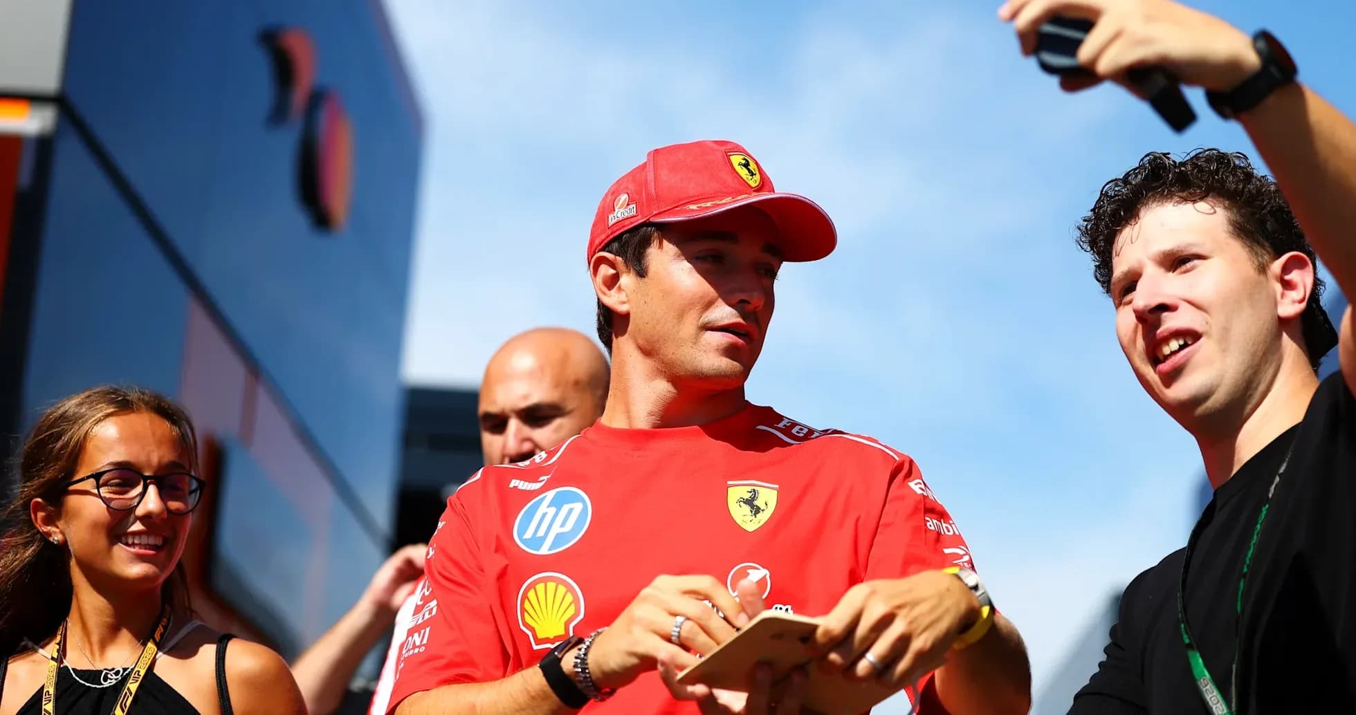 Driver interacting with fans outside team garage Driver interacting with fans outside team garage