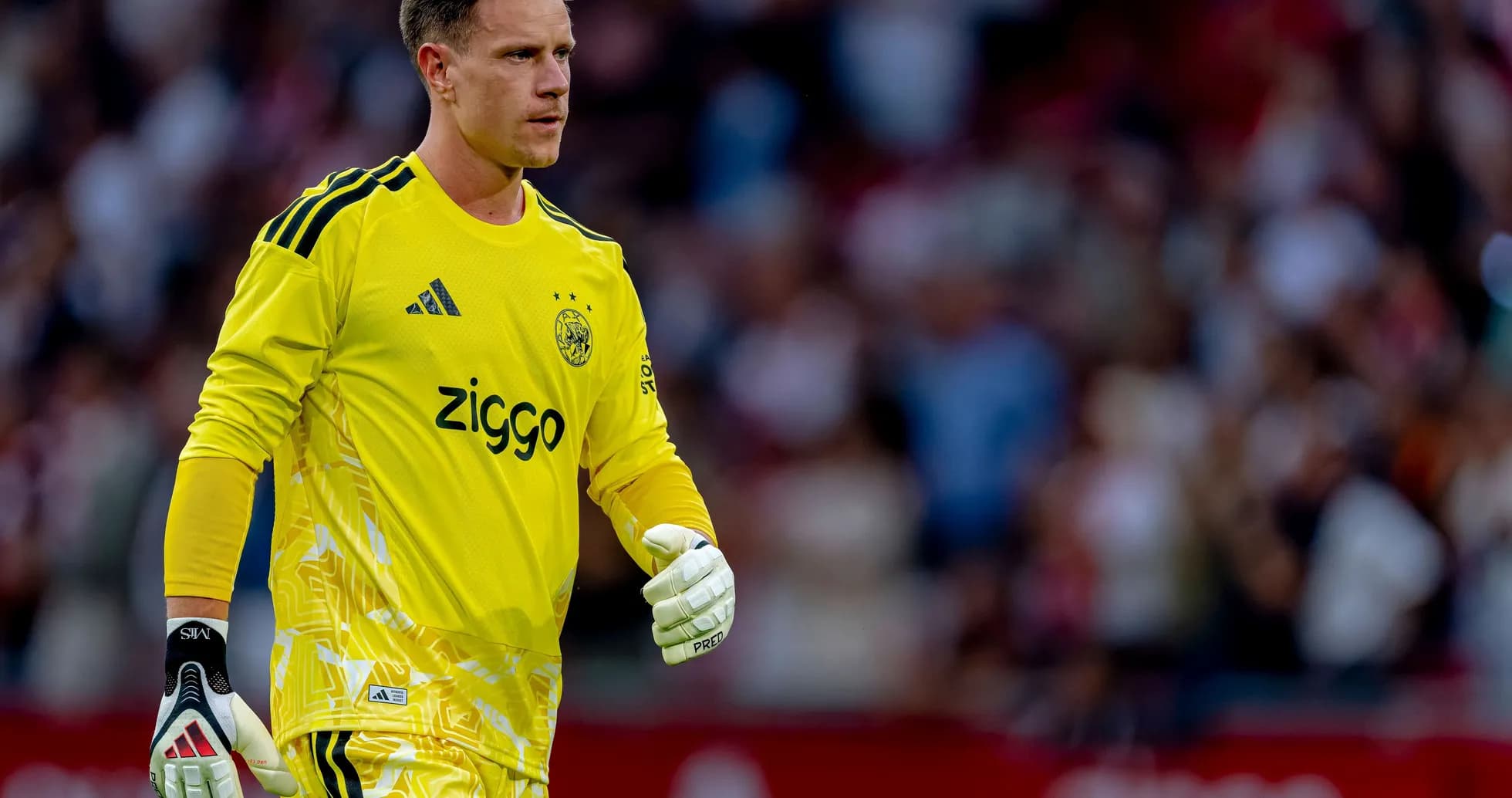 Goalkeeper in yellow jersey walking on the pitch Goalkeeper in yellow jersey walking on the pitch