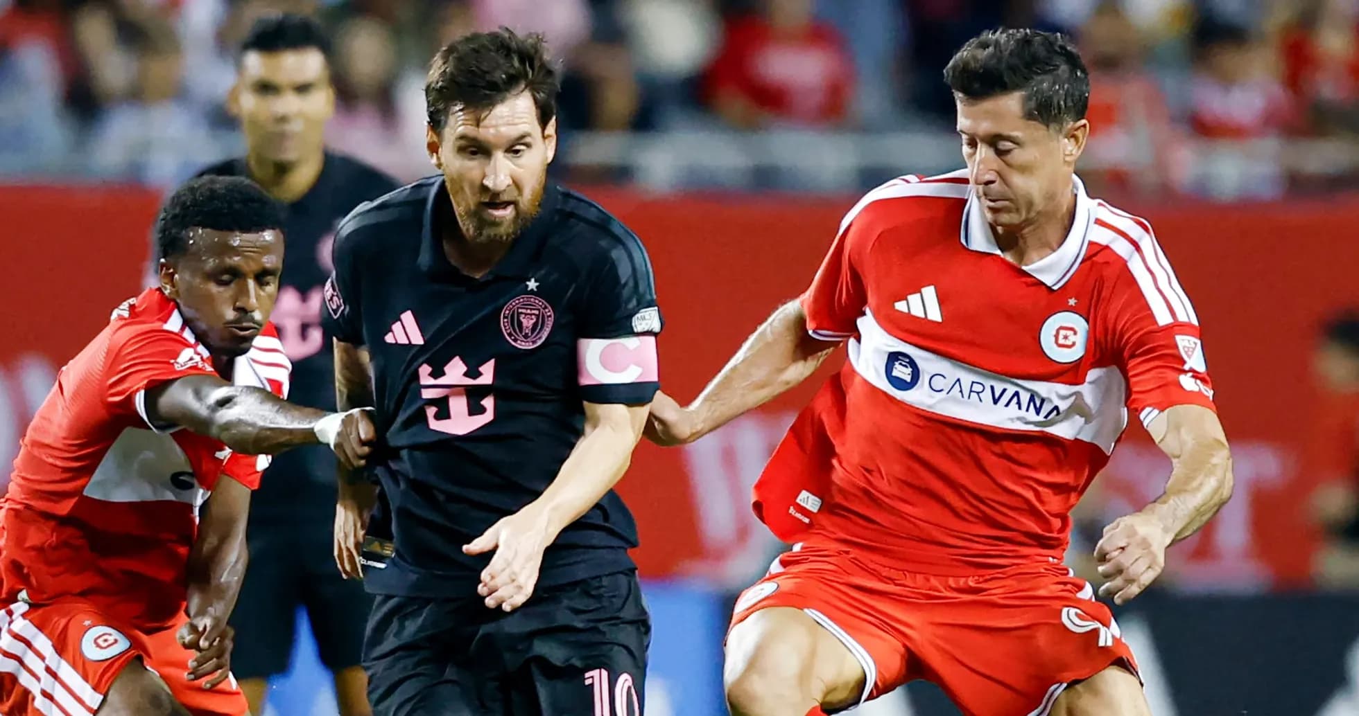 Players contesting the ball during a soccer match Players contesting the ball during a soccer match
