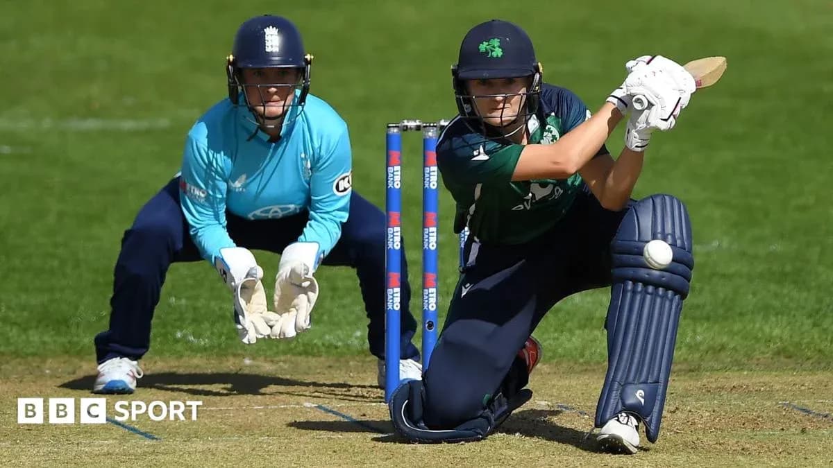 Batter playing a shot while wicketkeeper crouches Batter playing a shot while wicketkeeper crouches