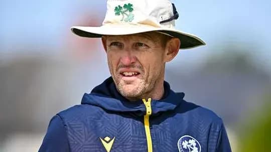 Cricket coach wearing a hat during training session Cricket coach wearing a hat during training session