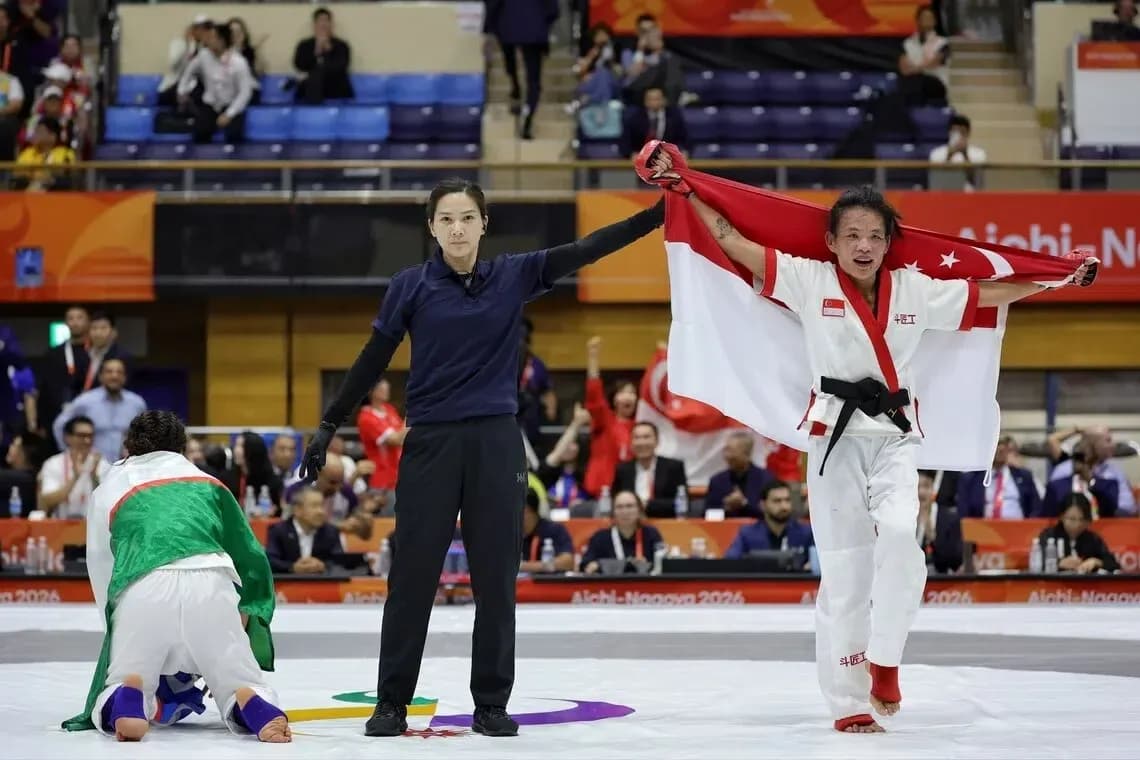 Athlete celebrating victory with national flag raised Athlete celebrating victory with national flag raised