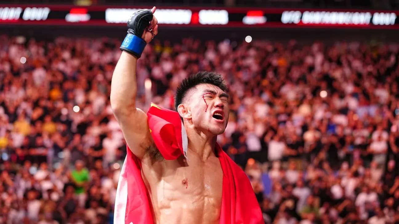 Fighter celebrating victory with flag after match Fighter celebrating victory with flag after match