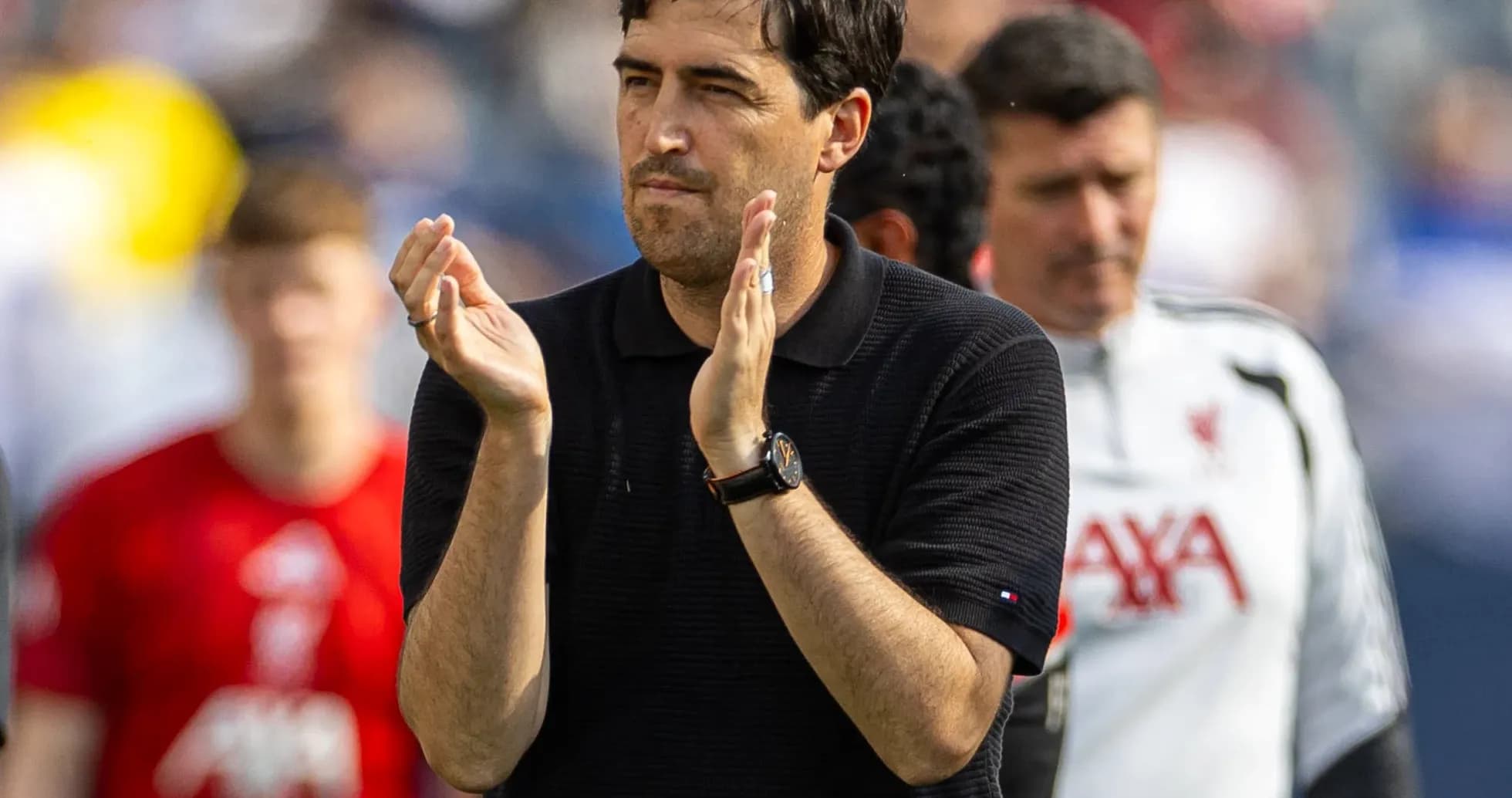 Coach applauding during match with team in background Coach applauding during match with team in background