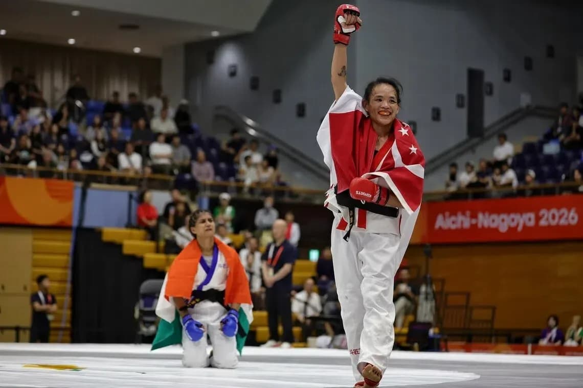 Winner celebrating with raised arm in karate match Winner celebrating with raised arm in karate match