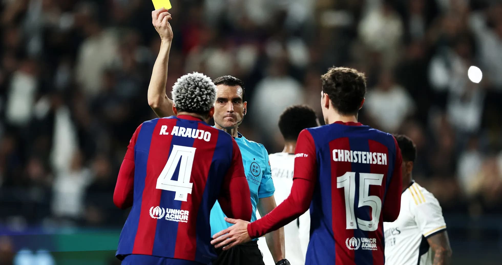 Referee showing yellow card to R. Araujo during match Referee showing yellow card to R. Araujo during match