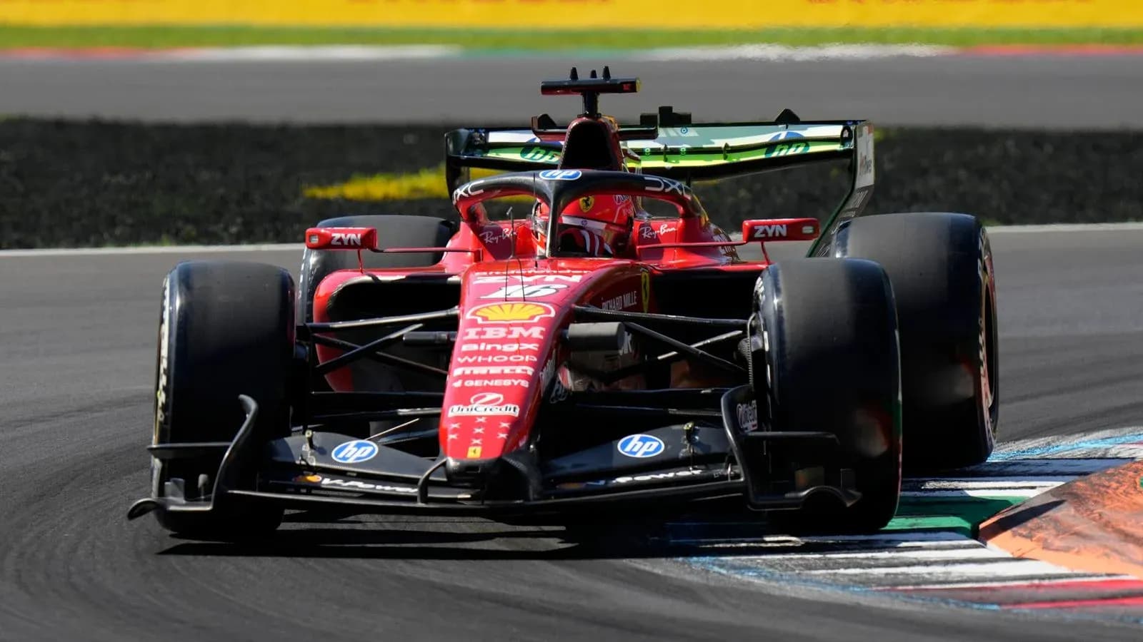Ferrari Formula 1 car taking a corner on track Ferrari Formula 1 car taking a corner on track