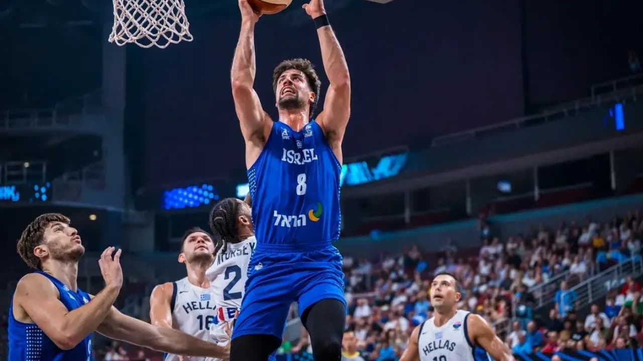 Player dunking during basketball game between Israel and Greece Player dunking during basketball game between Israel and Greece
