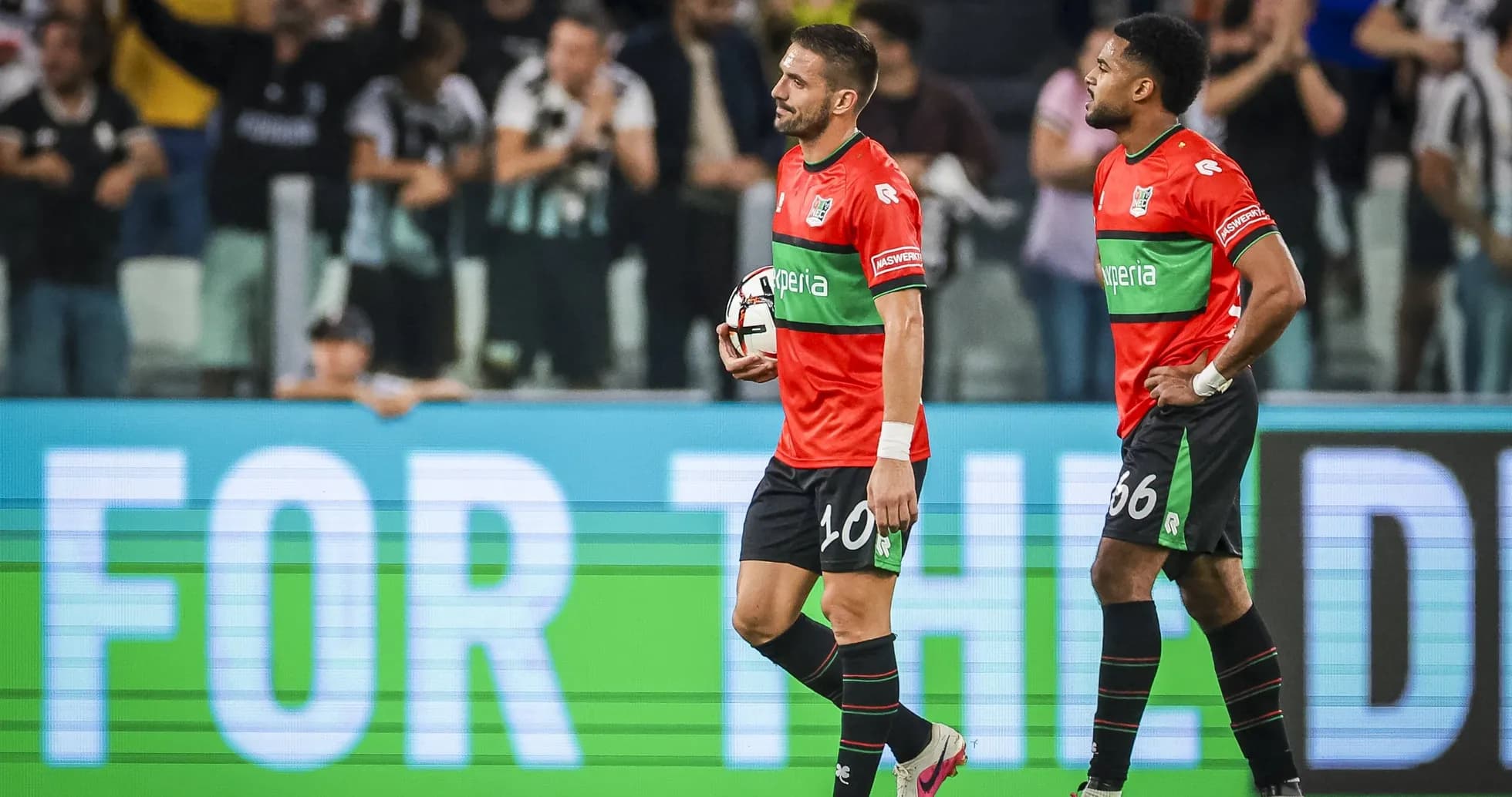 Two players walking off field after match Two players walking off field after match