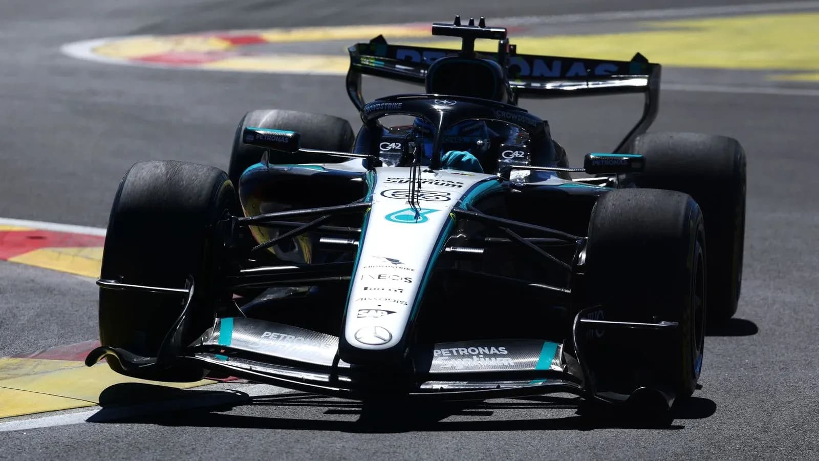 Mercedes Formula 1 car navigating a turn on track Mercedes Formula 1 car navigating a turn on track