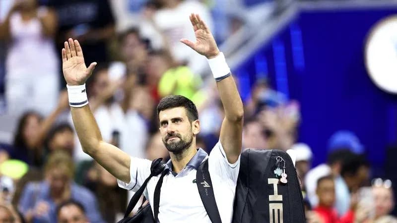 Tennis player waving to crowd after match Tennis player waving to crowd after match