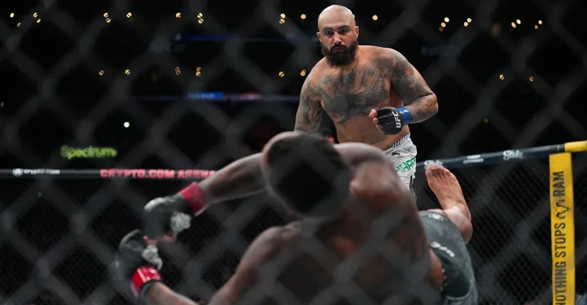 Fighter standing over opponent on the mat Fighter standing over opponent on the mat