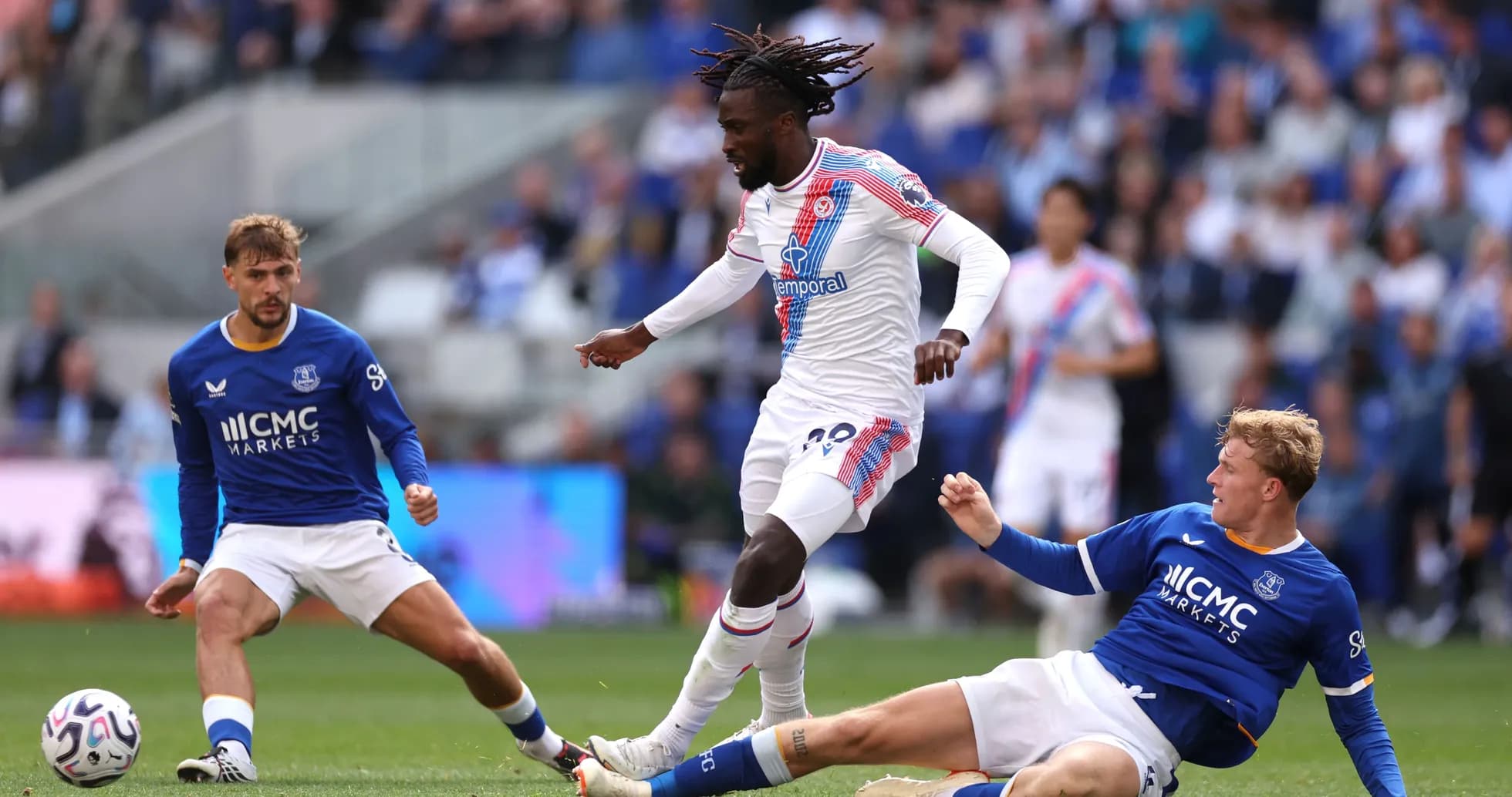 Crystal Palace player dribbling past Everton defenders Crystal Palace player dribbling past Everton defenders
