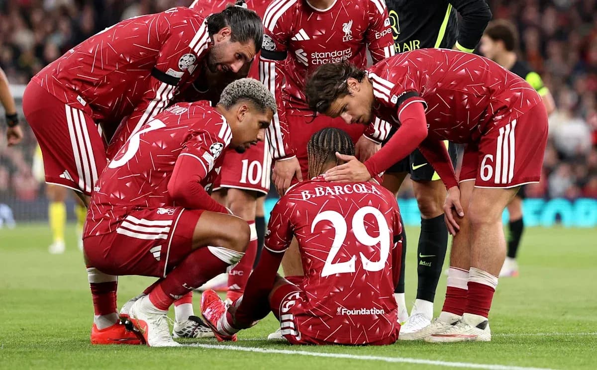 Liverpool players supporting teammate on the field Liverpool players supporting teammate on the field
