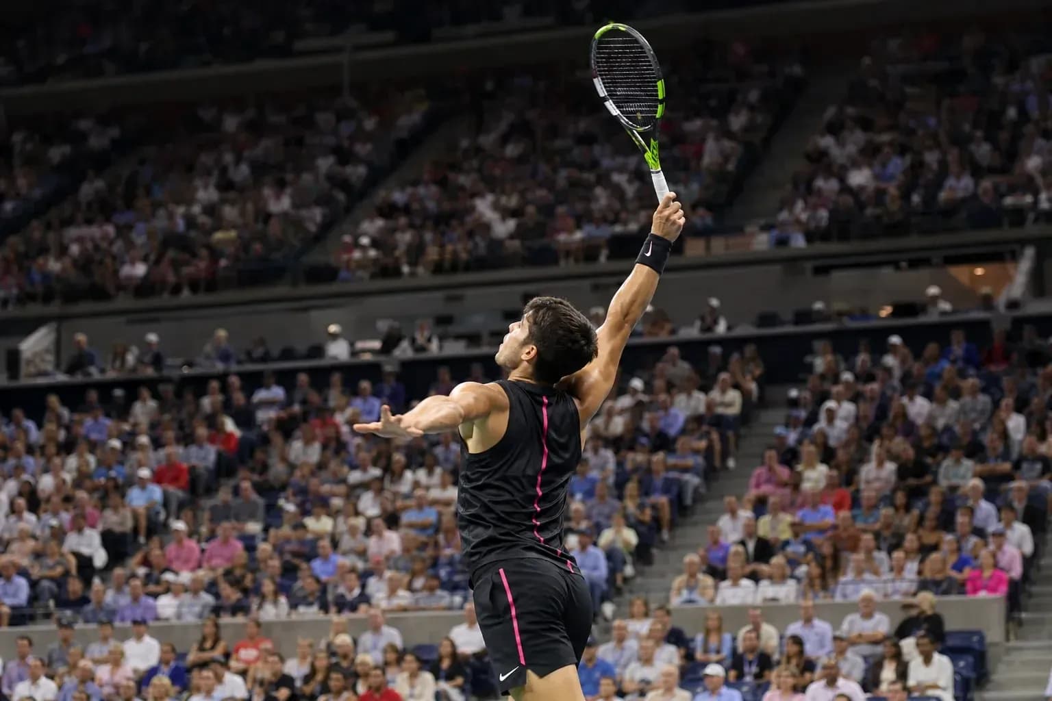 Player serving during a tennis match in stadium Player serving during a tennis match in stadium