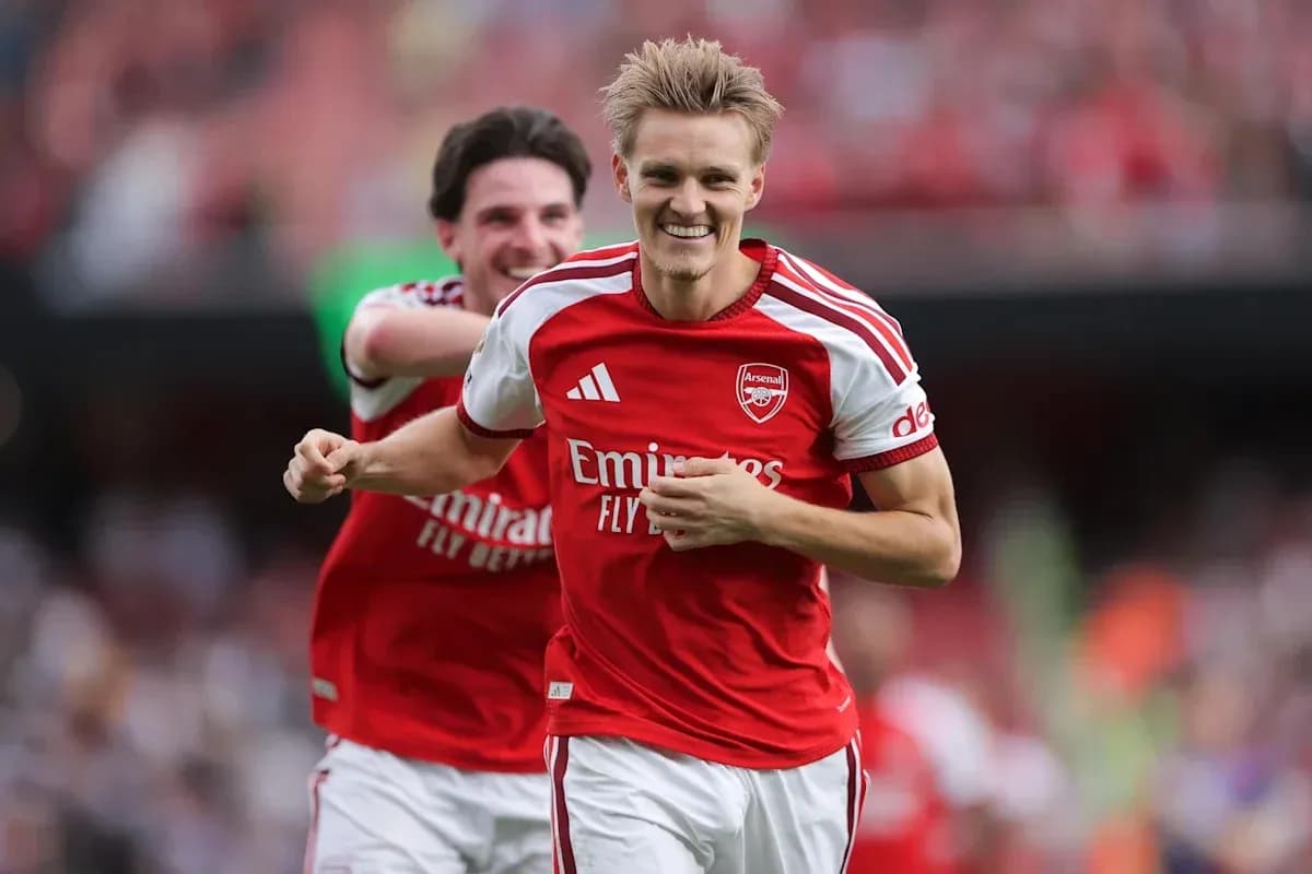 Arsenal player celebrating a goal on the pitch Arsenal player celebrating a goal on the pitch
