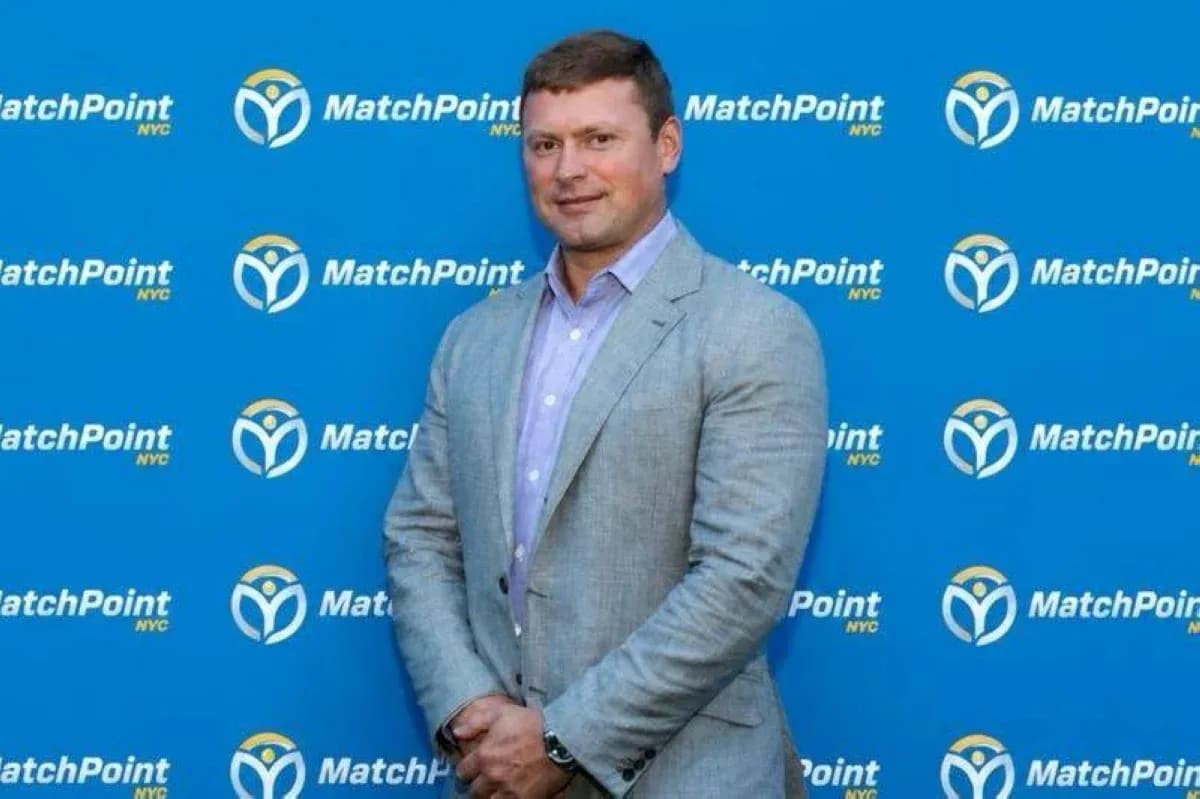 Person posing in front of MatchPoint NYC backdrop Person posing in front of MatchPoint NYC backdrop