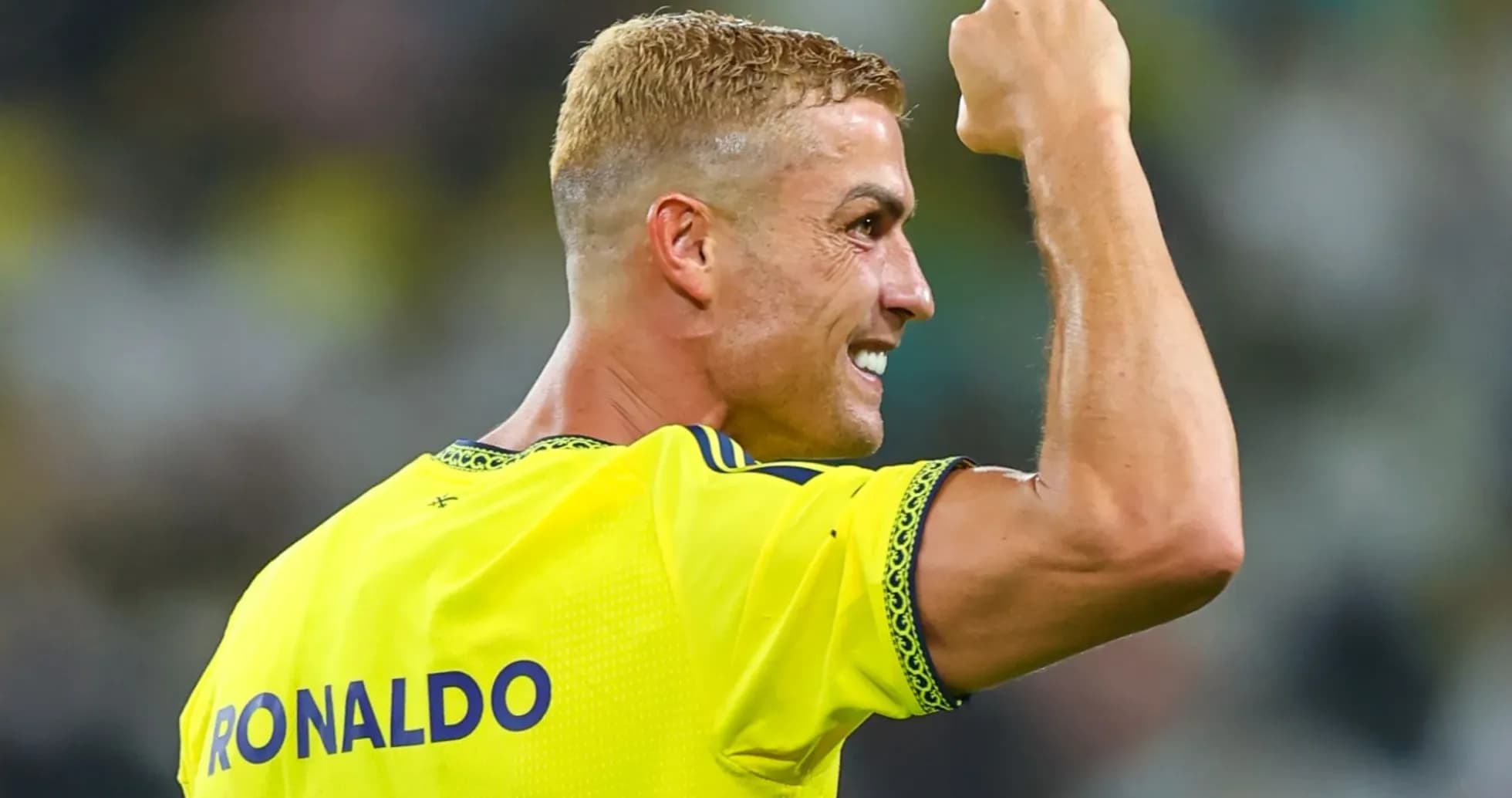Player celebrating with clenched fist on field Player celebrating with clenched fist on field