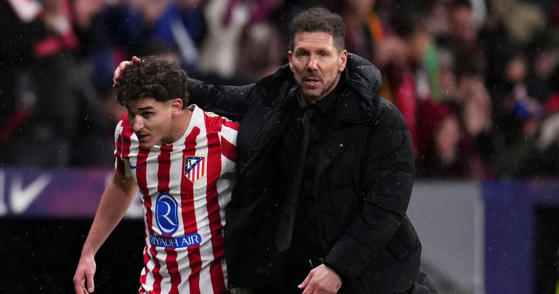 Atletico Madrid coach assisting player off the field Atletico Madrid coach assisting player off the field