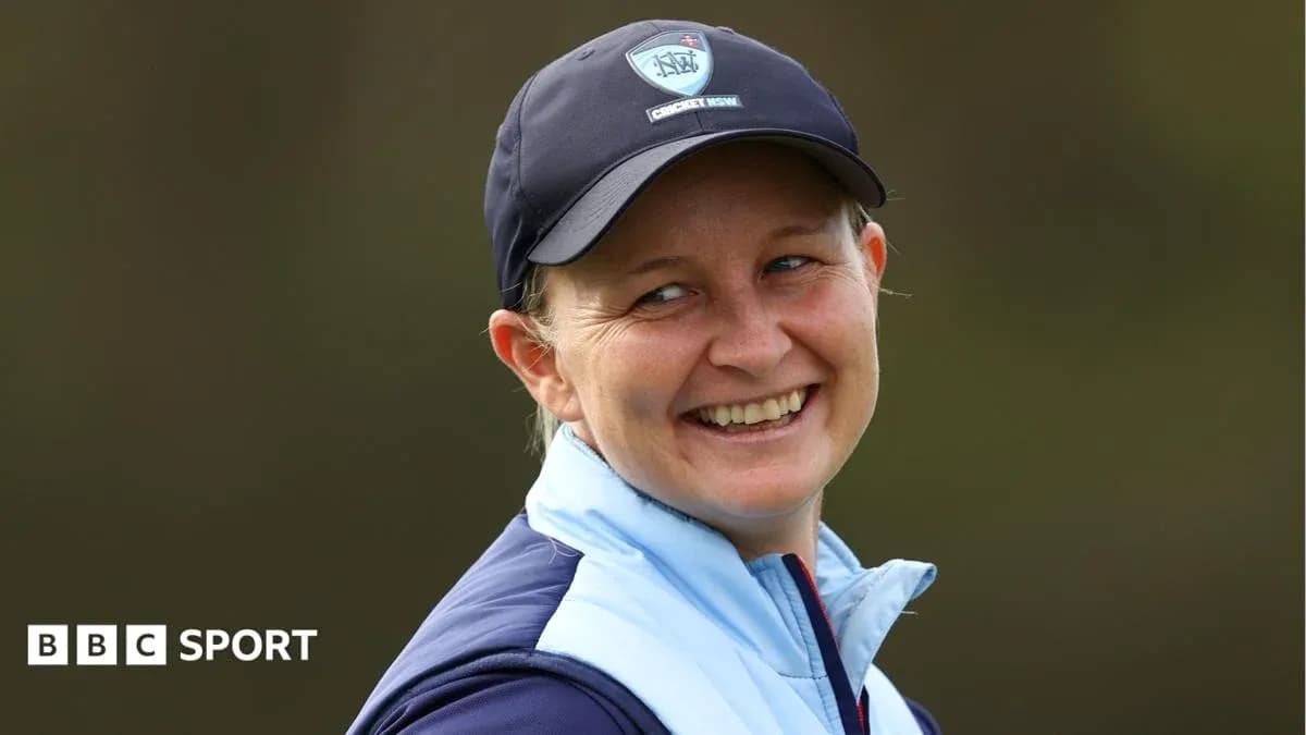 Smiling woman wearing a cricket cap and jacket Smiling woman wearing a cricket cap and jacket