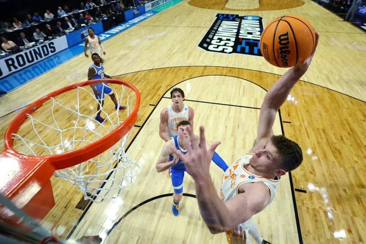Player dunking the basketball during NCAA tournament Player dunking the basketball during NCAA tournament