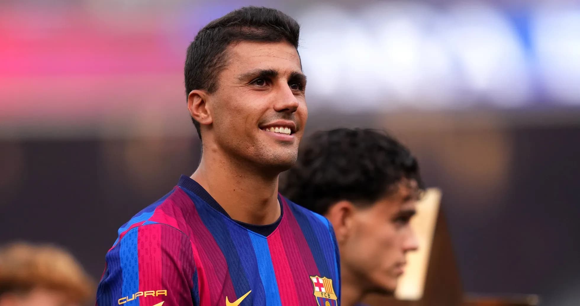 Player smiling in FC Barcelona jersey during event Player smiling in FC Barcelona jersey during event