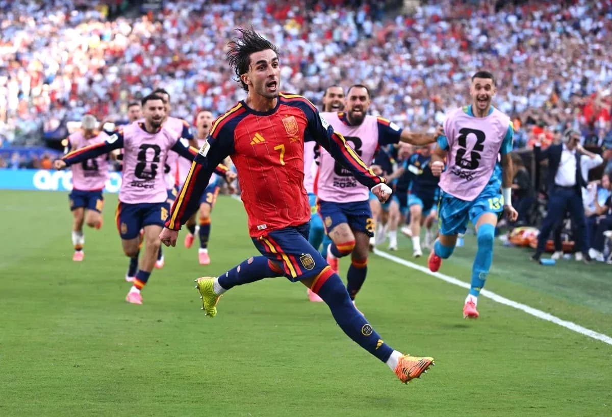 Spain player celebrating goal with teammates during match Spain player celebrating goal with teammates during match
