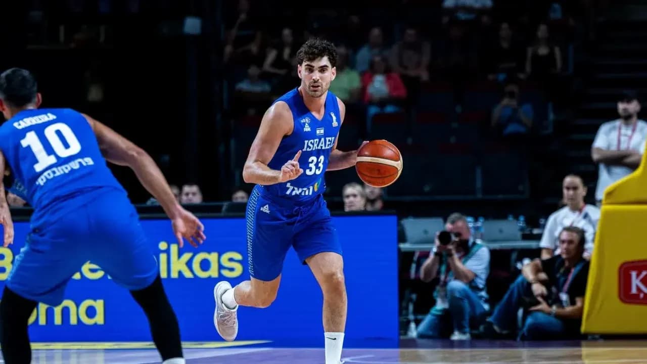 Israeli player dribbling basketball during game Israeli player dribbling basketball during game