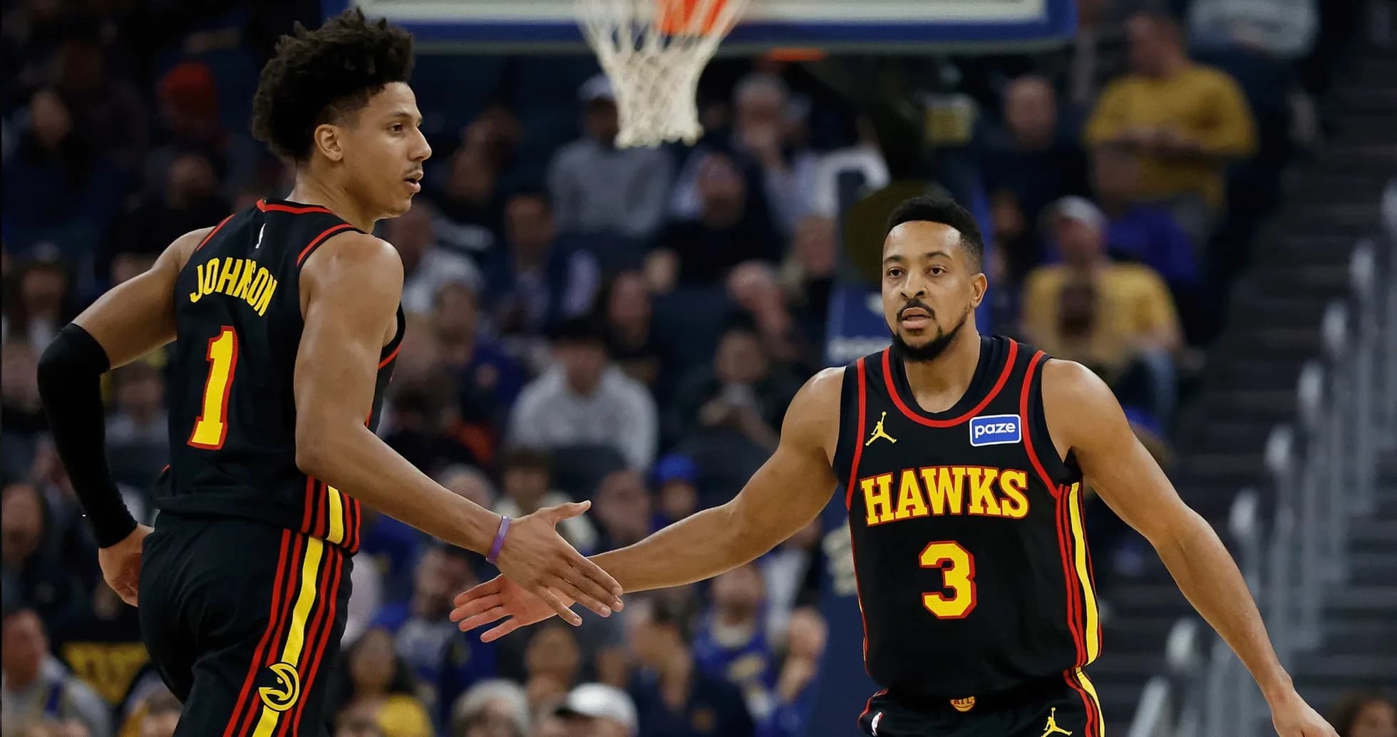 Two Atlanta Hawks players celebrating during a game Two Atlanta Hawks players celebrating during a game
