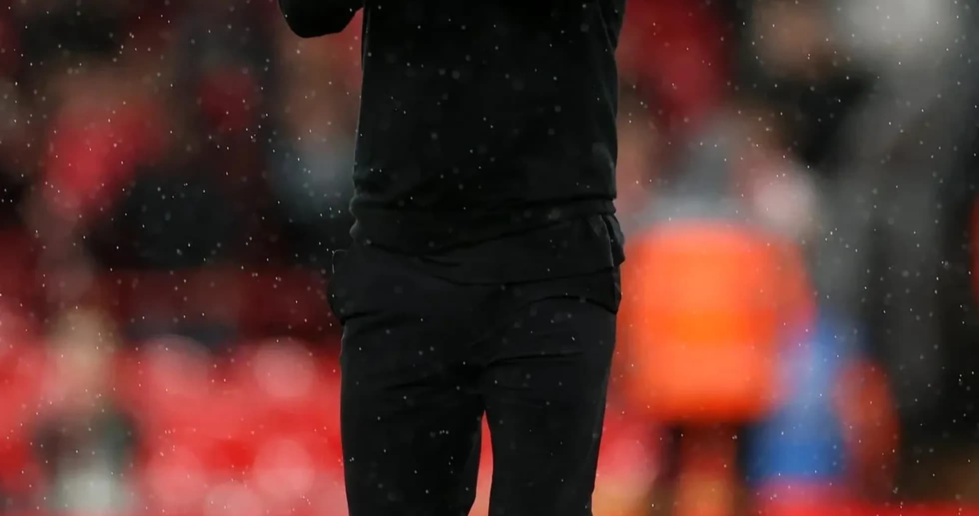 Coach applauding during a rainy match Coach applauding during a rainy match