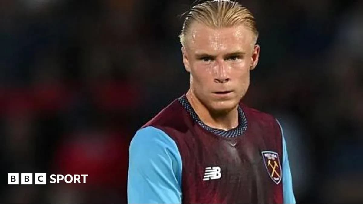 Player in West Ham United kit on the field Player in West Ham United kit on the field