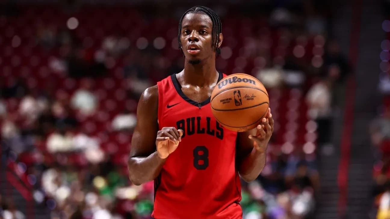 Player in Bulls jersey holding basketball during game Player in Bulls jersey holding basketball during game
