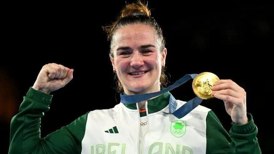 Athlete celebrating with gold medal and raised fist Athlete celebrating with gold medal and raised fist