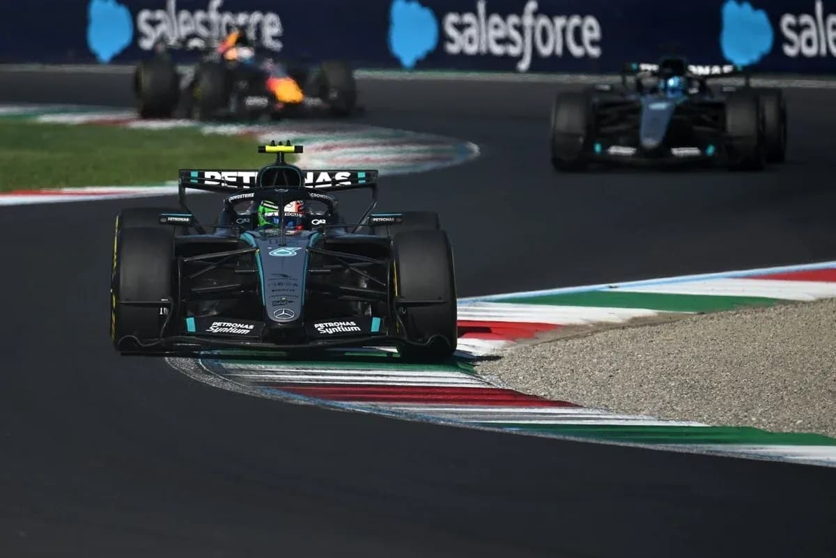 Mercedes Formula 1 car navigating a corner on track Mercedes Formula 1 car navigating a corner on track