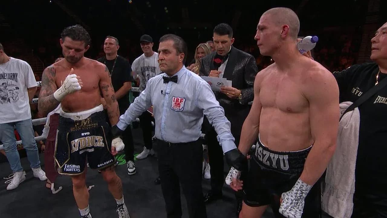Boxers waiting for decision with referee in ring Boxers waiting for decision with referee in ring