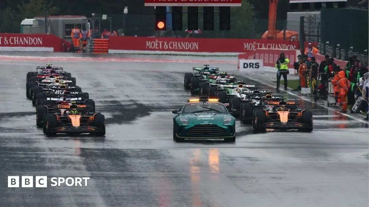 Cars lined up on wet track before race start Cars lined up on wet track before race start