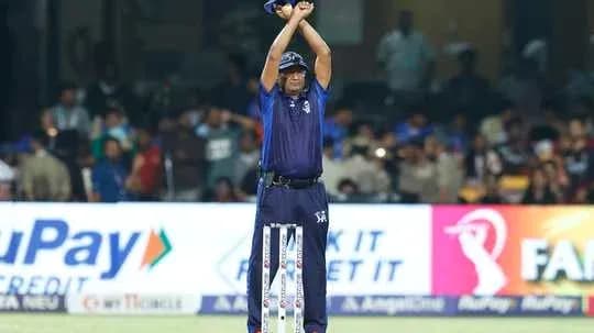 Umpire signaling during a cricket match Umpire signaling during a cricket match