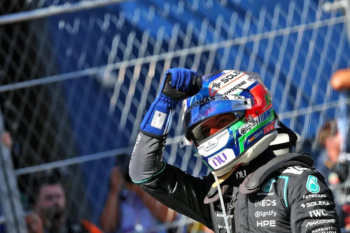 Racing driver celebrating with raised fist in helmet Racing driver celebrating with raised fist in helmet