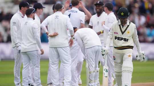 Pakistani batsman walking past celebrating fielding team Pakistani batsman walking past celebrating fielding team
