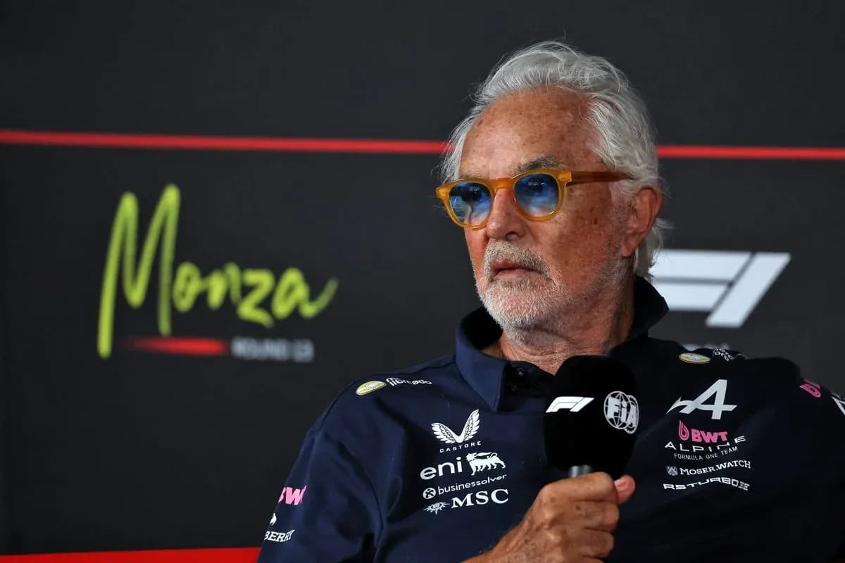 Man speaking at press conference with Monza backdrop Man speaking at press conference with Monza backdrop