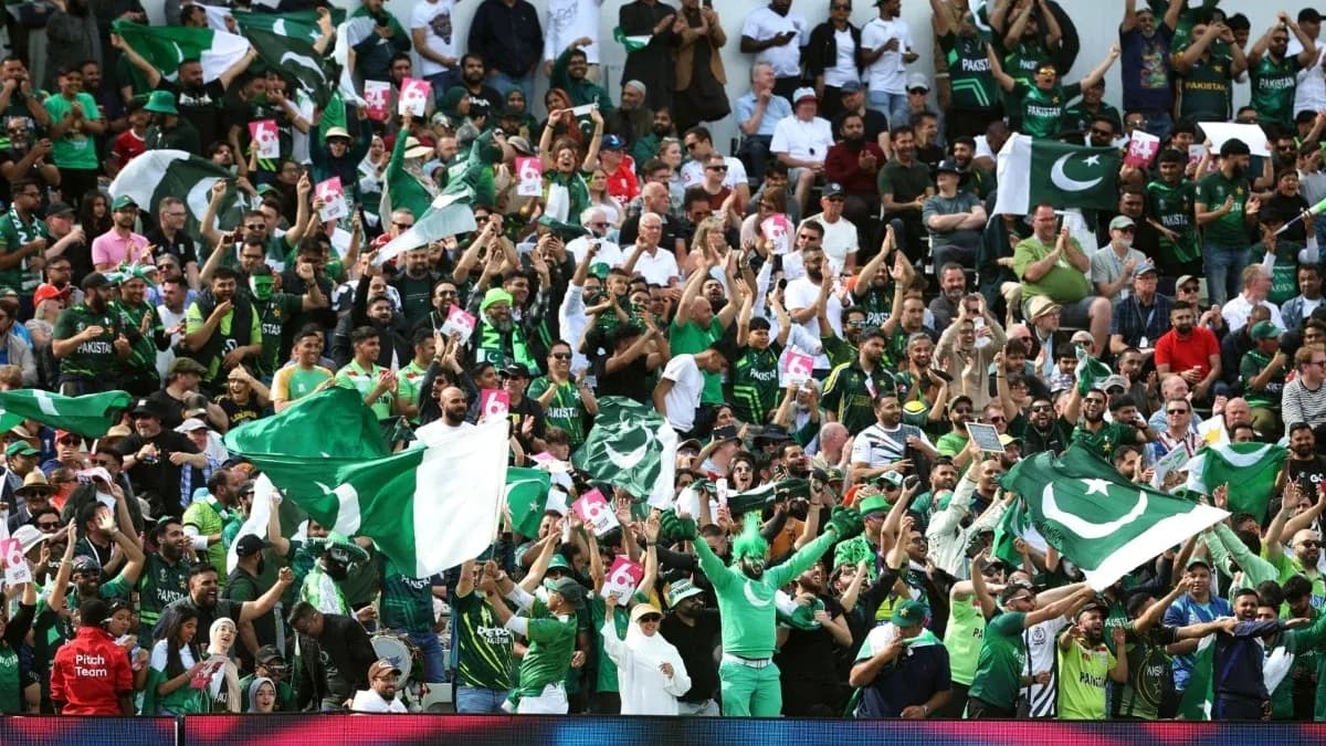 Crowd of fans cheering with flags at stadium Crowd of fans cheering with flags at stadium