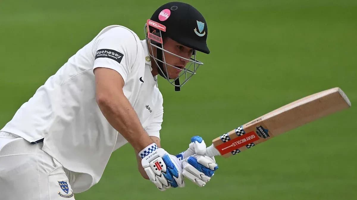 Cricketer batting with a wooden bat on field Cricketer batting with a wooden bat on field