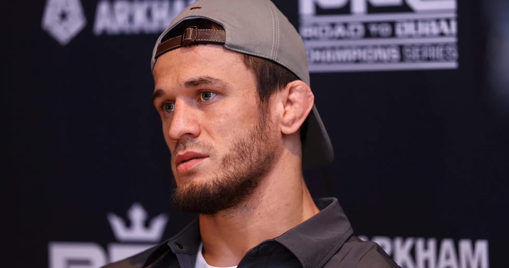 Athlete at press conference wearing a cap Athlete at press conference wearing a cap