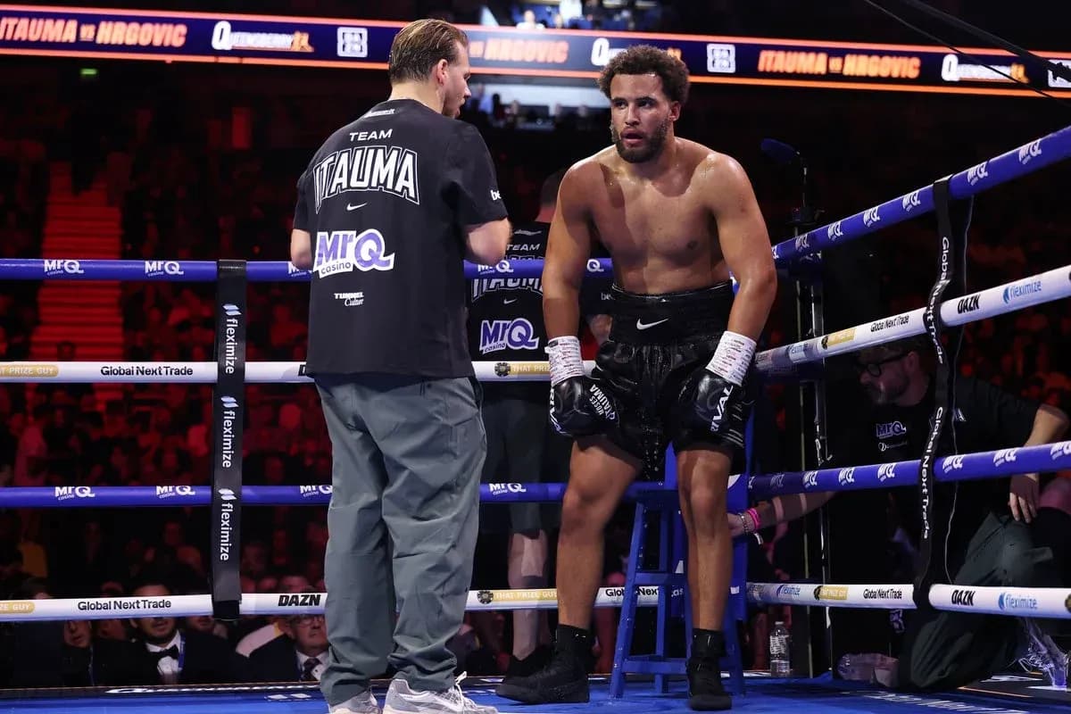 Boxer sitting on stool receiving advice from coach Boxer sitting on stool receiving advice from coach