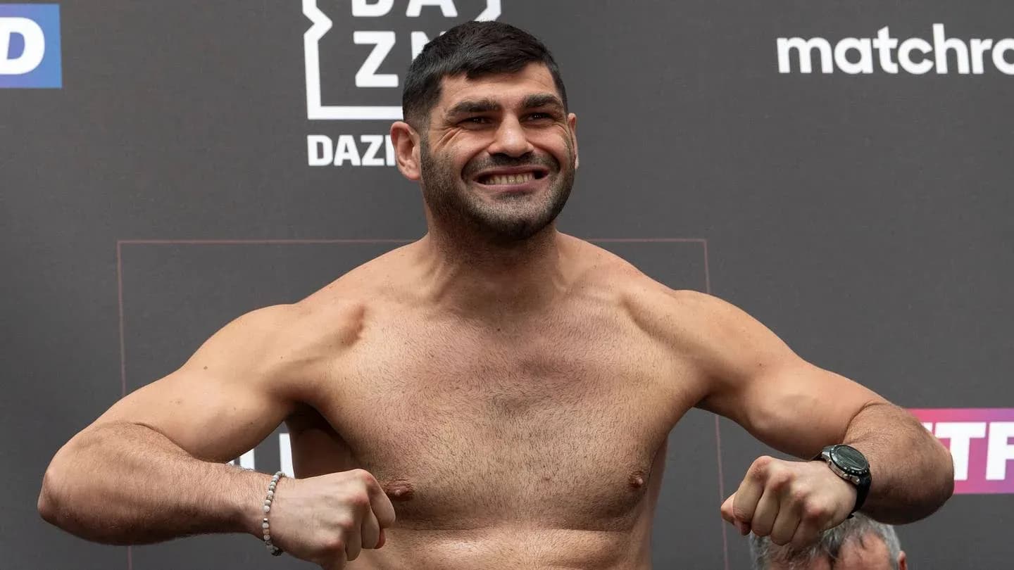 Fighter posing on scale at weigh-in event Fighter posing on scale at weigh-in event