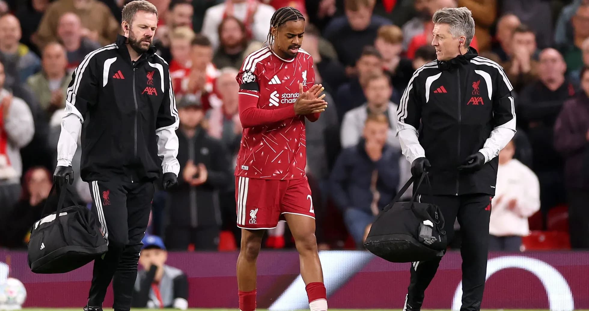 Liverpool player leaving field with medical staff Liverpool player leaving field with medical staff
