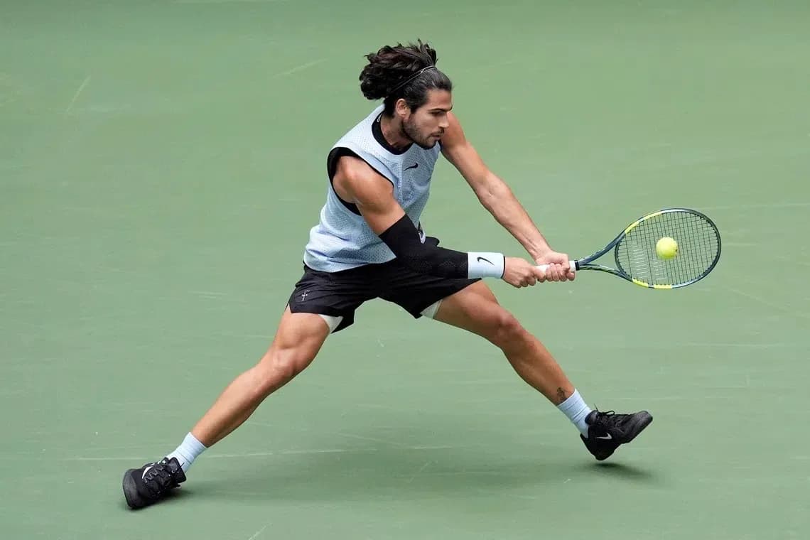Tennis player hitting a backhand shot on court Tennis player hitting a backhand shot on court