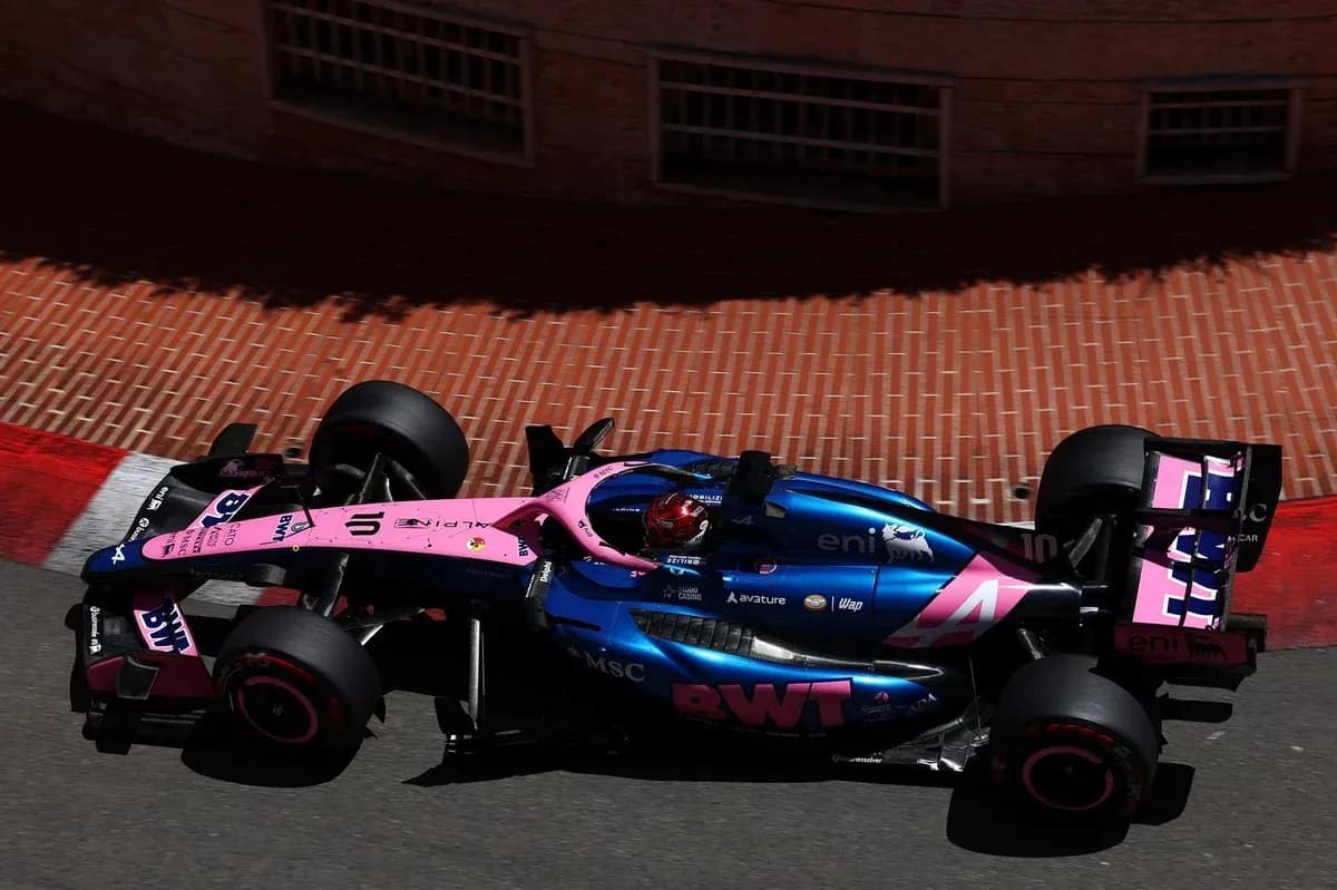 Formula 1 car navigating a corner on track Formula 1 car navigating a corner on track