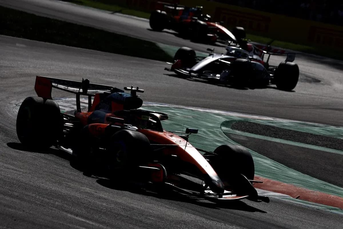Formula 1 cars racing on a curved track Formula 1 cars racing on a curved track