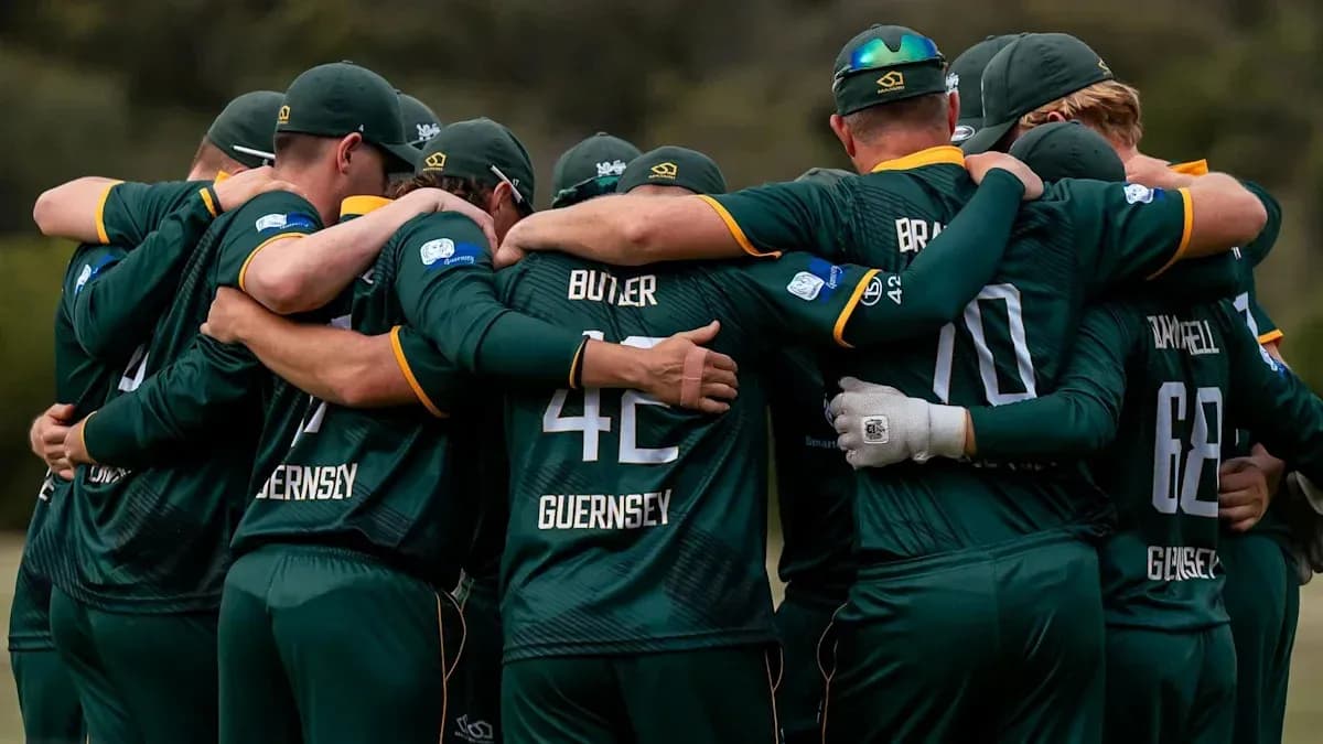 Cricket team huddled together in green uniforms Cricket team huddled together in green uniforms